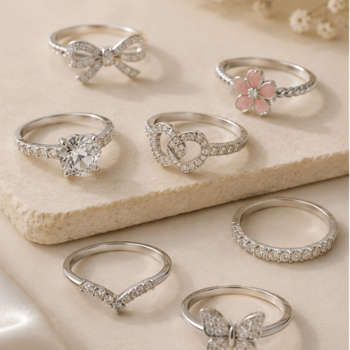 "Elegant artificial rings with sparkling crystal designs displayed on a soft beige background for women."