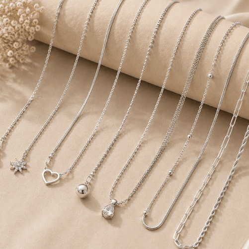 "Elegant silver chain collection featuring minimalist pendant and classic chain designs displayed on a soft beige luxury background."